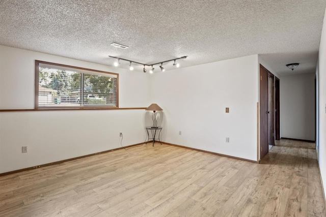 14417 N Dakota Rd, Spokane, WA 99208 - spare room with light wood-style floors and a textured ceiling