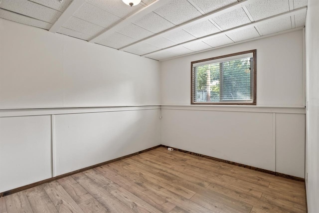 14417 N Dakota Rd, Spokane, WA 99208 - spare room featuring a decorative wall, light wood-style flooring, and a drop ceiling