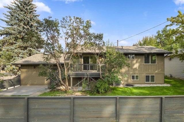 14417 N Dakota Rd, Spokane, WA 99208 - rear view of house with a fenced backyard, roof with shingles, and a deck