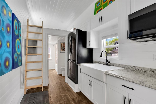 14417 N Dakota Rd, Spokane, WA 99208 - kitchen featuring freestanding refrigerator, white cabinetry, dark wood-type flooring, light stone counters, and wooden ceiling
