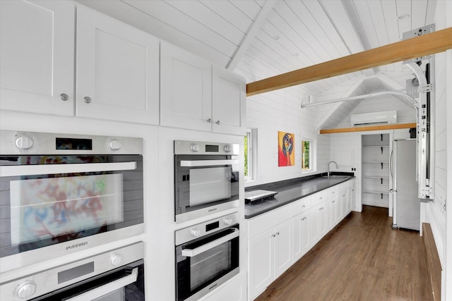 14417 N Dakota Rd, Spokane, WA 99208 - kitchen with double oven, dark countertops, freestanding refrigerator, and white cabinetry