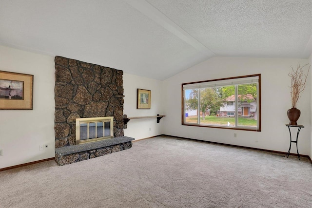 14417 N Dakota Rd, Spokane, WA 99208 - unfurnished living room featuring carpet, vaulted ceiling, a stone fireplace, and a textured ceiling