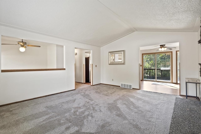 14417 N Dakota Rd, Spokane, WA 99208 - unfurnished living room with ceiling fan, vaulted ceiling, carpet flooring, and a textured ceiling