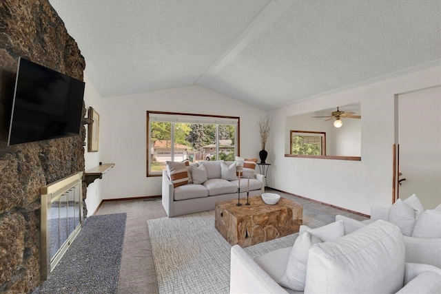14417 N Dakota Rd, Spokane, WA 99208 - carpeted living area with lofted ceiling, a fireplace with flush hearth, a textured ceiling, and ceiling fan