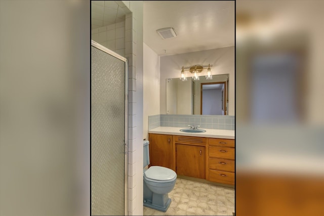9405 N Normandie Ln, Spokane, WA 99218 - bathroom featuring a stall shower, vanity, tile patterned floors, and backsplash