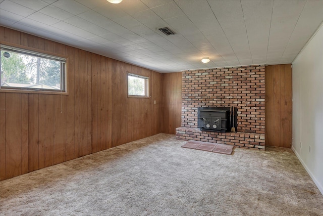 9405 N Normandie Ln, Spokane, WA 99218 - unfurnished living room with carpet floors, a wood stove, and wood walls