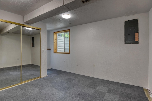 9405 N Normandie Ln, Spokane, WA 99218 - below grade area featuring electric panel, carpet flooring, a textured wall, and a textured ceiling