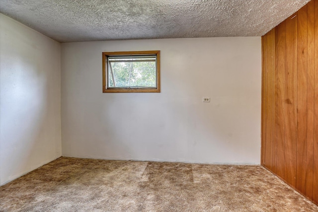 9405 N Normandie Ln, Spokane, WA 99218 - carpeted empty room with a textured ceiling and wooden walls