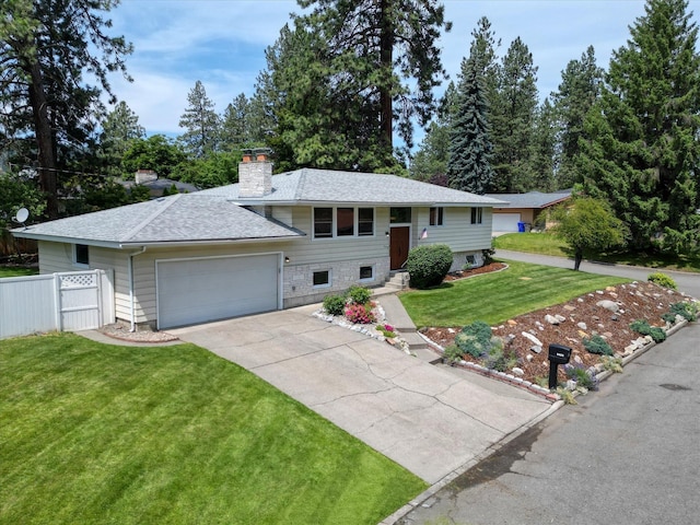 9405 N Normandie Ln, Spokane, WA 99218 - bi-level home featuring a garage, a chimney, driveway, and roof with shingles