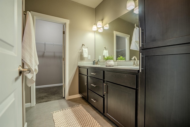 2303 W Bridge Ave, Spokane, WA 99201 - full bath with double vanity, a spacious closet, and tile patterned floors