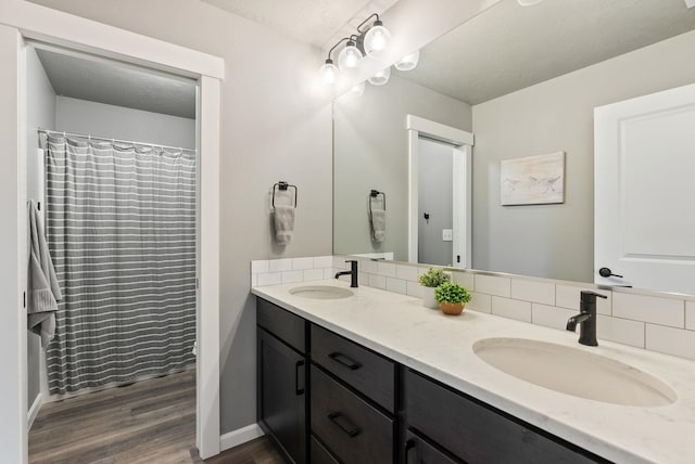 4513 S Crows Nest Ln, Spokane, WA 99206 - full bath featuring backsplash, double vanity, and wood finished floors