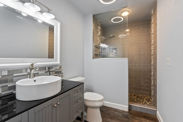 4513 S Crows Nest Ln, Spokane, WA 99206 - full bath featuring a walk in shower, vanity, wood finished floors, and decorative backsplash