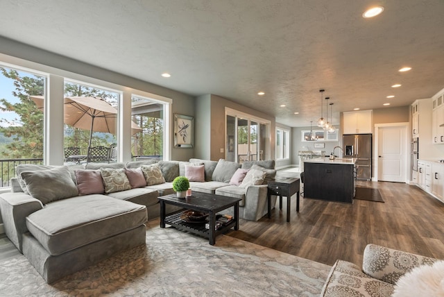 4513 S Crows Nest Ln, Spokane, WA 99206 - living room featuring dark wood-style floors, recessed lighting, and a chandelier