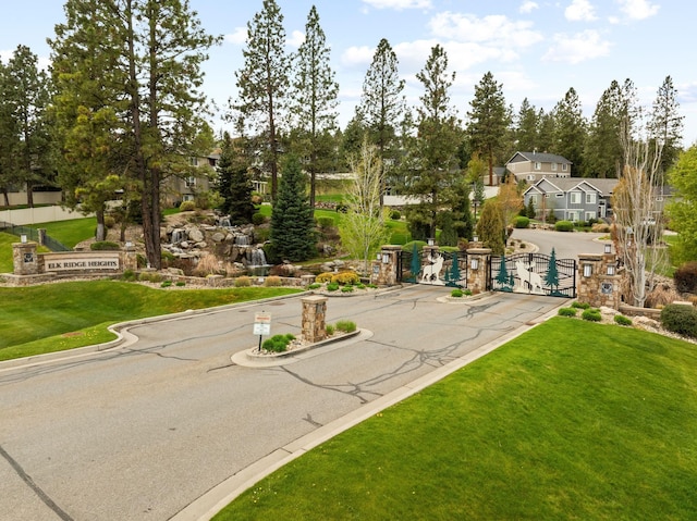 4513 S Crows Nest Ln, Spokane, WA 99206 - view of asphalt street with a gated entry, curbs, a gate, and a residential view
