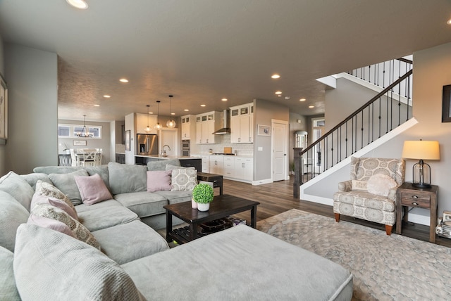 4513 S Crows Nest Ln, Spokane, WA 99206 - living room with dark wood finished floors, recessed lighting, stairs, and a chandelier