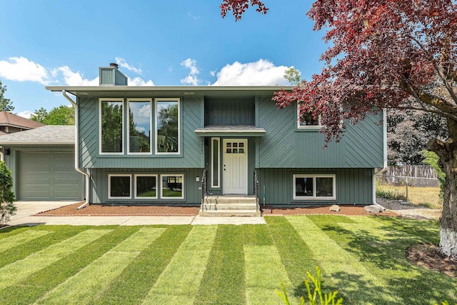 7721 N Wilding Dr, Spokane, WA 99208 - split foyer home featuring an attached garage, a chimney, and driveway
