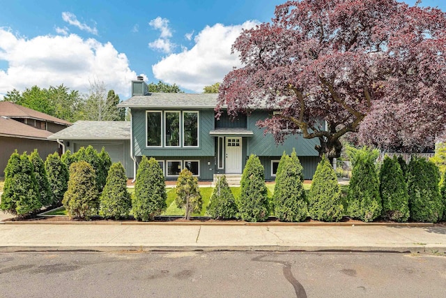 7721 N Wilding Dr, Spokane, WA 99208 - raised ranch featuring a chimney and an attached garage