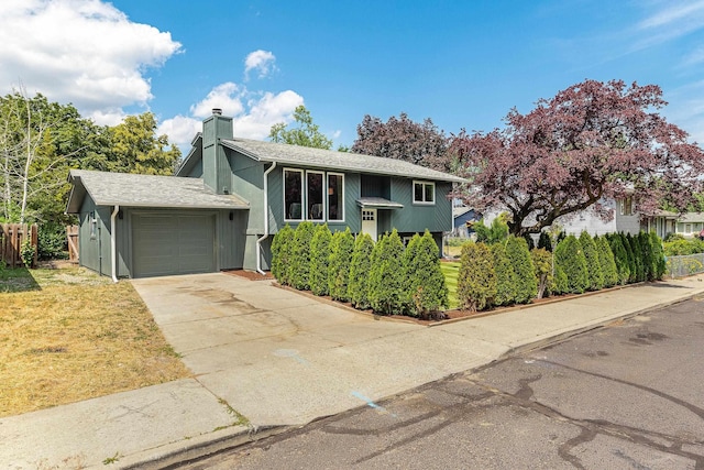 7721 N Wilding Dr, Spokane, WA 99208 - raised ranch featuring an attached garage, a chimney, and driveway