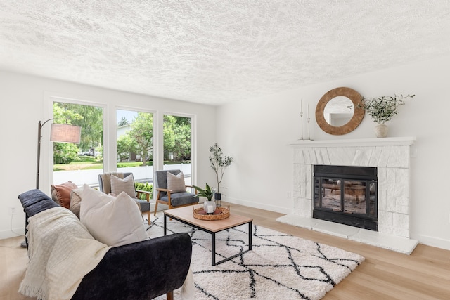 7721 N Wilding Dr, Spokane, WA 99208 - living room featuring a textured ceiling, wood finished floors, and a fireplace