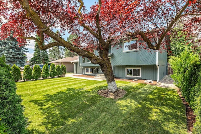 7721 N Wilding Dr, Spokane, WA 99208 - rear view of house featuring a lawn and a garage