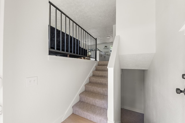 7721 N Wilding Dr, Spokane, WA 99208 - stairs with a textured ceiling and baseboards