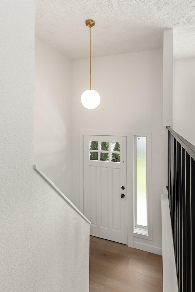 7721 N Wilding Dr, Spokane, WA 99208 - foyer entrance featuring light wood-type flooring and a textured ceiling
