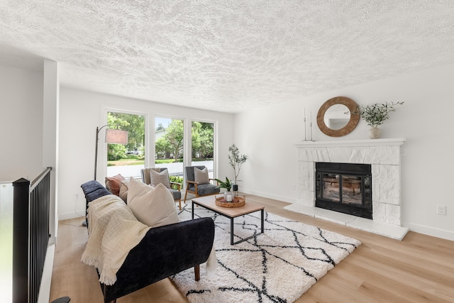 7721 N Wilding Dr, Spokane, WA 99208 - living area featuring a textured ceiling, wood finished floors, and a fireplace