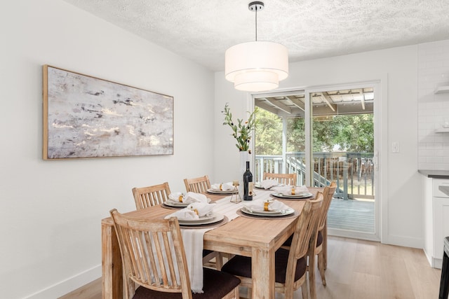 7721 N Wilding Dr, Spokane, WA 99208 - dining room with light wood finished floors and a textured ceiling