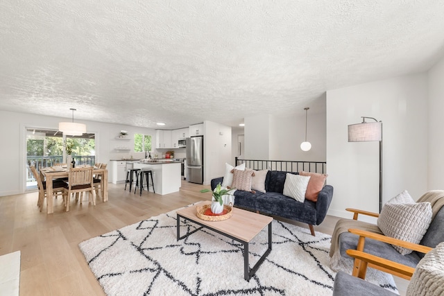 7721 N Wilding Dr, Spokane, WA 99208 - living area featuring a textured ceiling and light wood-type flooring