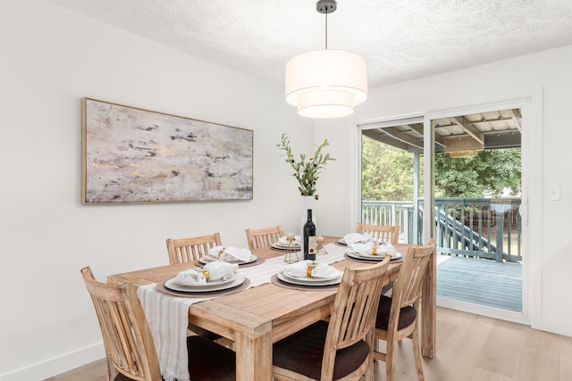 7721 N Wilding Dr, Spokane, WA 99208 - dining room with light wood-style floors and a textured ceiling