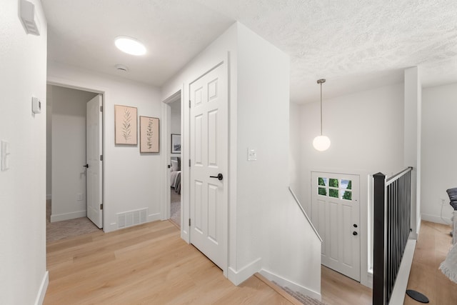 7721 N Wilding Dr, Spokane, WA 99208 - entryway featuring light wood-type flooring and a textured ceiling