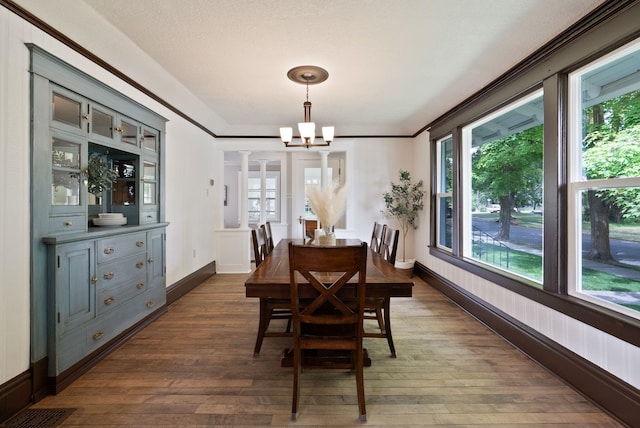 1315 N Hollis St, Spokane, WA 99201 - dining room featuring a chandelier, dark wood-type flooring, and plenty of natural light