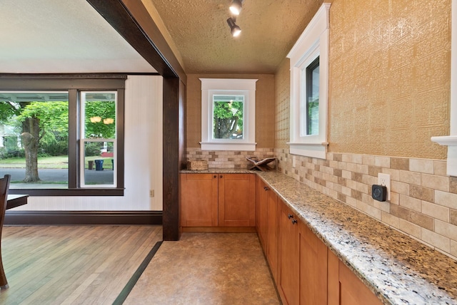1315 N Hollis St, Spokane, WA 99201 - bar area featuring backsplash, light wood-style floors, track lighting, and a textured ceiling