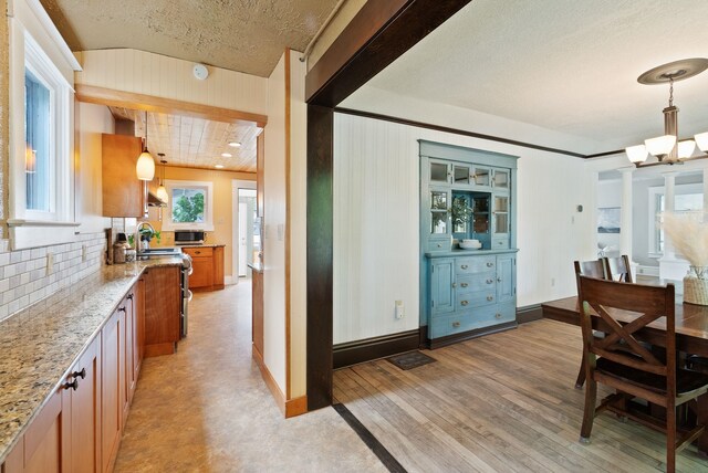 1315 N Hollis St, Spokane, WA 99201 - dining room featuring a chandelier, a textured ceiling, and light wood-style flooring