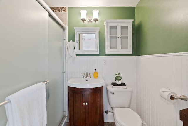 1315 N Hollis St, Spokane, WA 99201 - bathroom with a shower with door, wainscoting, and vanity