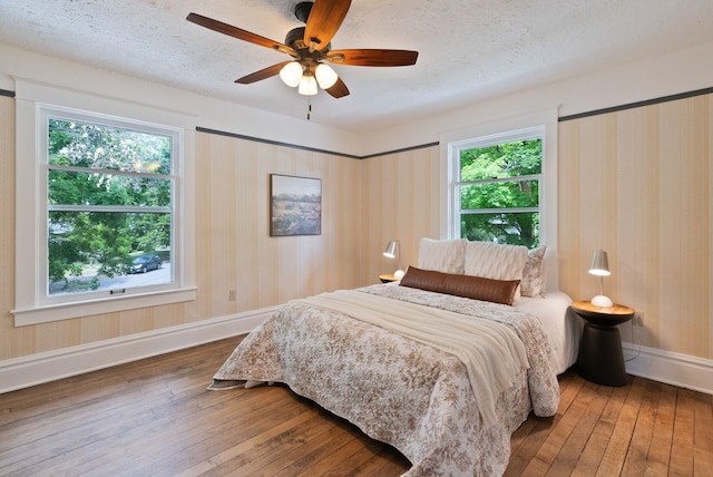 1315 N Hollis St, Spokane, WA 99201 - bedroom with wood-type flooring, ceiling fan, and a textured ceiling