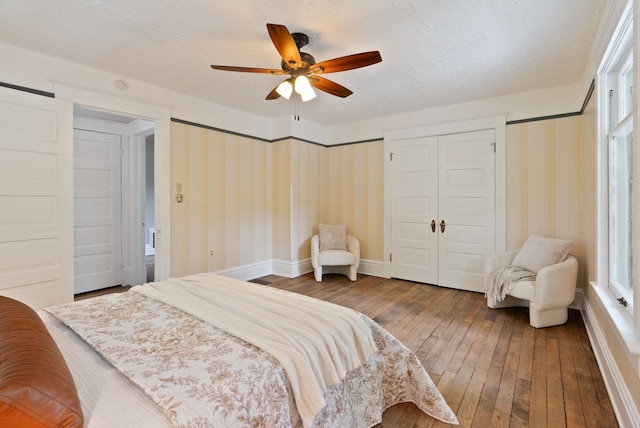 1315 N Hollis St, Spokane, WA 99201 - bedroom with hardwood / wood-style floors, wallpapered walls, ceiling fan, and a textured ceiling
