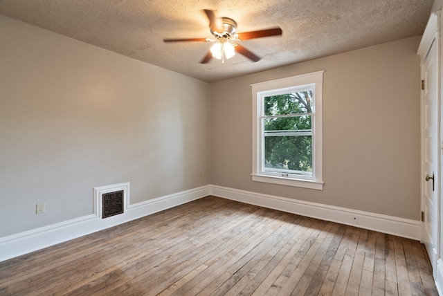 1315 N Hollis St, Spokane, WA 99201 - empty room with ceiling fan, hardwood / wood-style flooring, and a textured ceiling