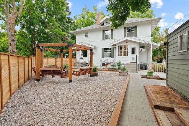 1315 N Hollis St, Spokane, WA 99201 - rear view of property featuring a chimney, a fenced backyard, a patio, and entry steps