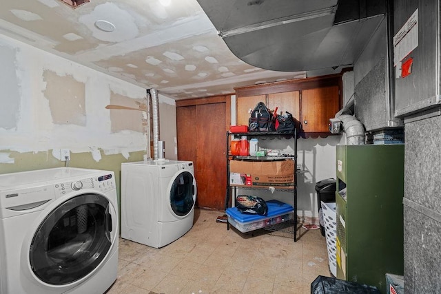 1630 E Broad Ave, Spokane, WA 99207 - washroom with washer and dryer, light flooring, and cabinet space