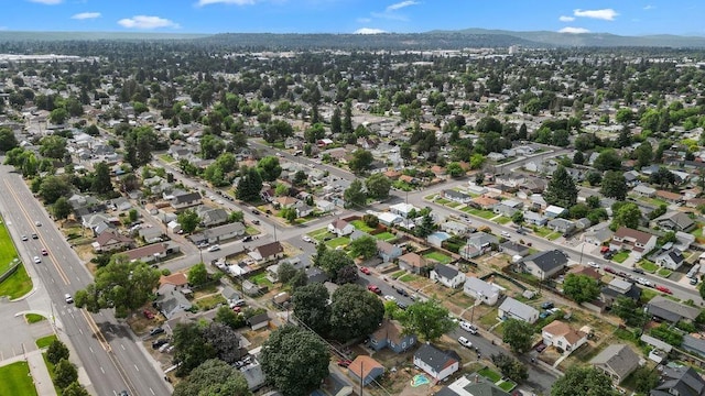 1630 E Broad Ave, Spokane, WA 99207 - aerial overview of property's location with a mountainous background and nearby suburban area