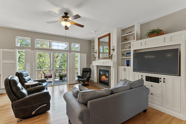 718 W Qualchan Ln, Spokane, WA 99224 - living area with a ceiling fan, a glass covered fireplace, light wood-style floors, and built in shelves