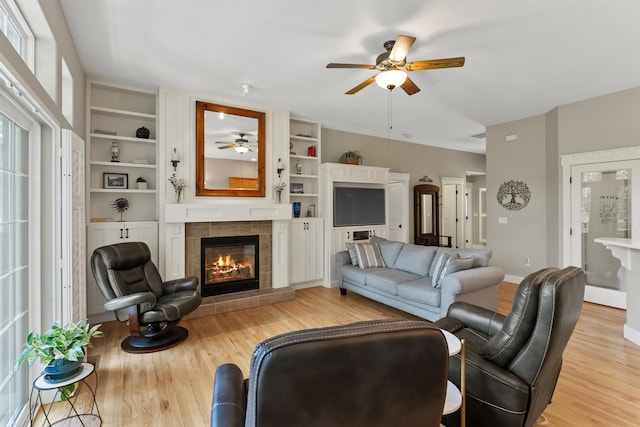 718 W Qualchan Ln, Spokane, WA 99224 - living area with ceiling fan, a fireplace, light wood-style flooring, and built in features