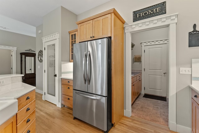 718 W Qualchan Ln, Spokane, WA 99224 - kitchen with freestanding refrigerator, light wood finished floors, light countertops, and light brown cabinetry