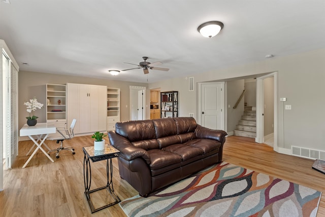 718 W Qualchan Ln, Spokane, WA 99224 - living area featuring a ceiling fan, light wood finished floors, a desk, and stairway