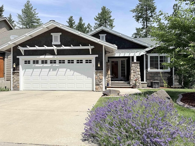 718 W Qualchan Ln, Spokane, WA 99224 - craftsman inspired home featuring stone siding, an attached garage, driveway, and a shingled roof