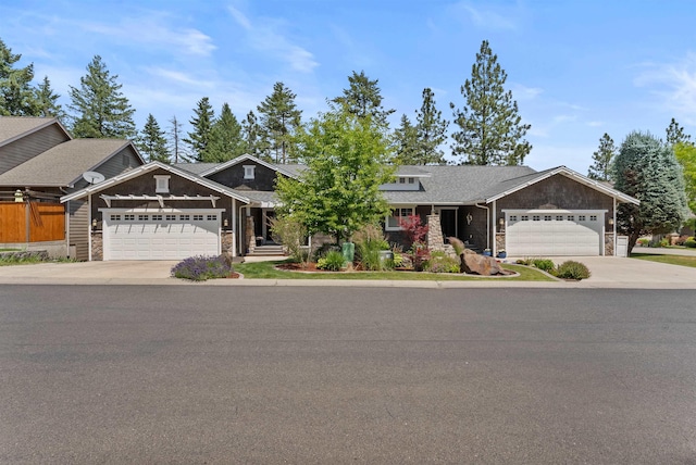 718 W Qualchan Ln, Spokane, WA 99224 - craftsman inspired home featuring stone siding, an attached garage, and driveway