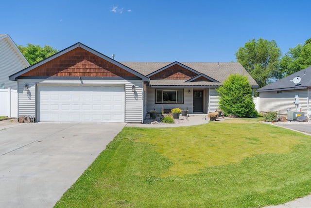 1819 N Center Ln, Spokane Valley, WA 99212 - view of front of house featuring a front lawn, a garage, concrete driveway, and roof with shingles