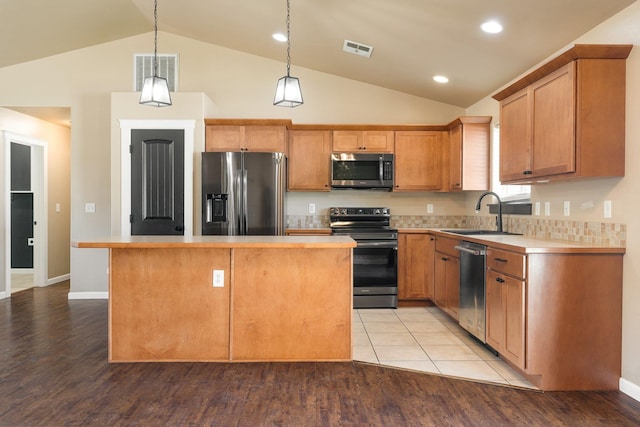 1819 N Center Ln, Spokane Valley, WA 99212 - kitchen with stainless steel appliances, a center island, light countertops, light wood-style floors, and high vaulted ceiling