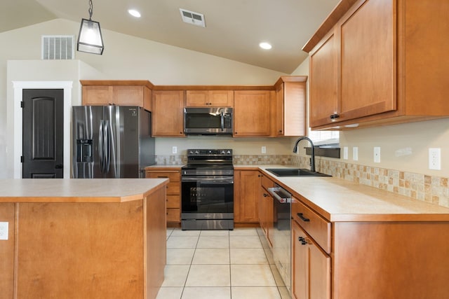 1819 N Center Ln, Spokane Valley, WA 99212 - kitchen featuring stainless steel appliances, lofted ceiling, light countertops, light tile patterned floors, and decorative light fixtures